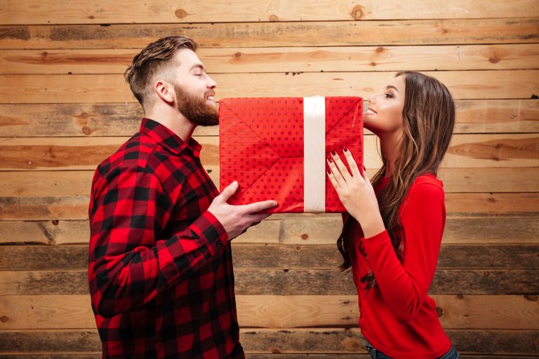 Man and woman holding a gift